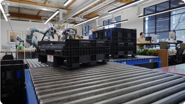 Rhoda AI robot performing manufacturing tasks on a production line