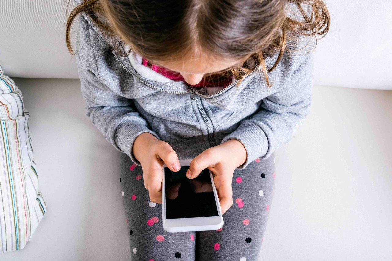 Teenager using smartphone with AI chatbot app