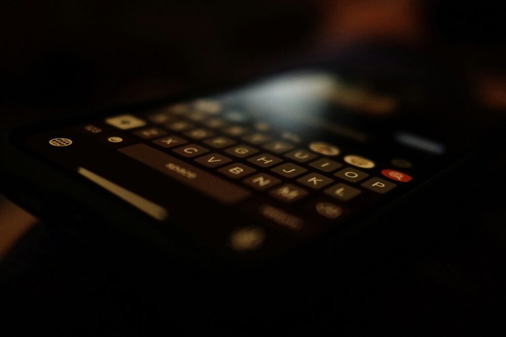 Smartphone keyboard in dark lighting representing private messaging