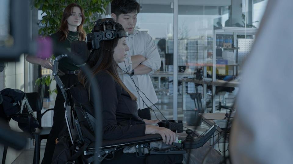 Breanna Olson wearing an EEG headset for brain-computer interface training during the Dentsu Lab Waves of Will AI-powered dance project